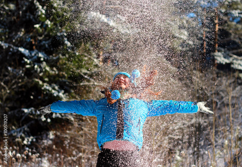 girl spread her arms and jumped catching snowflakes