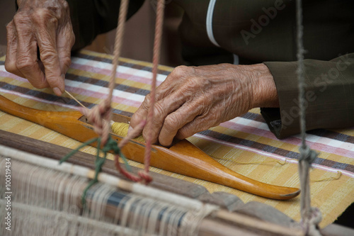 Woman weaving silk in traditional way at manual loom. Thailand © Suwatchai
