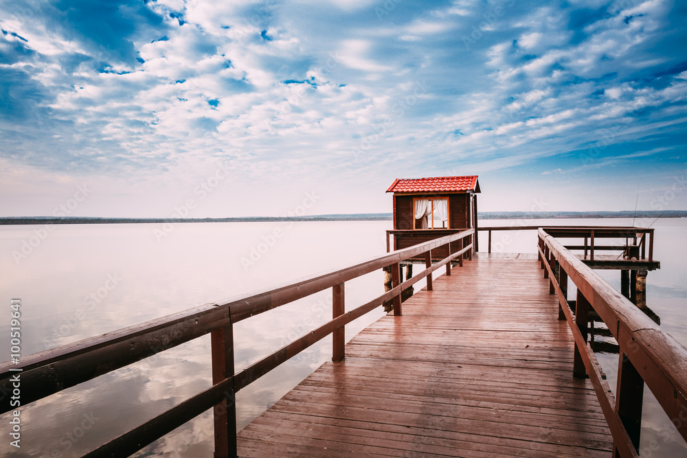 Beautiful wooden pier for fishing, small wooden house shed and b Beautiful wooden pier for fishing, small wooden house shed and b