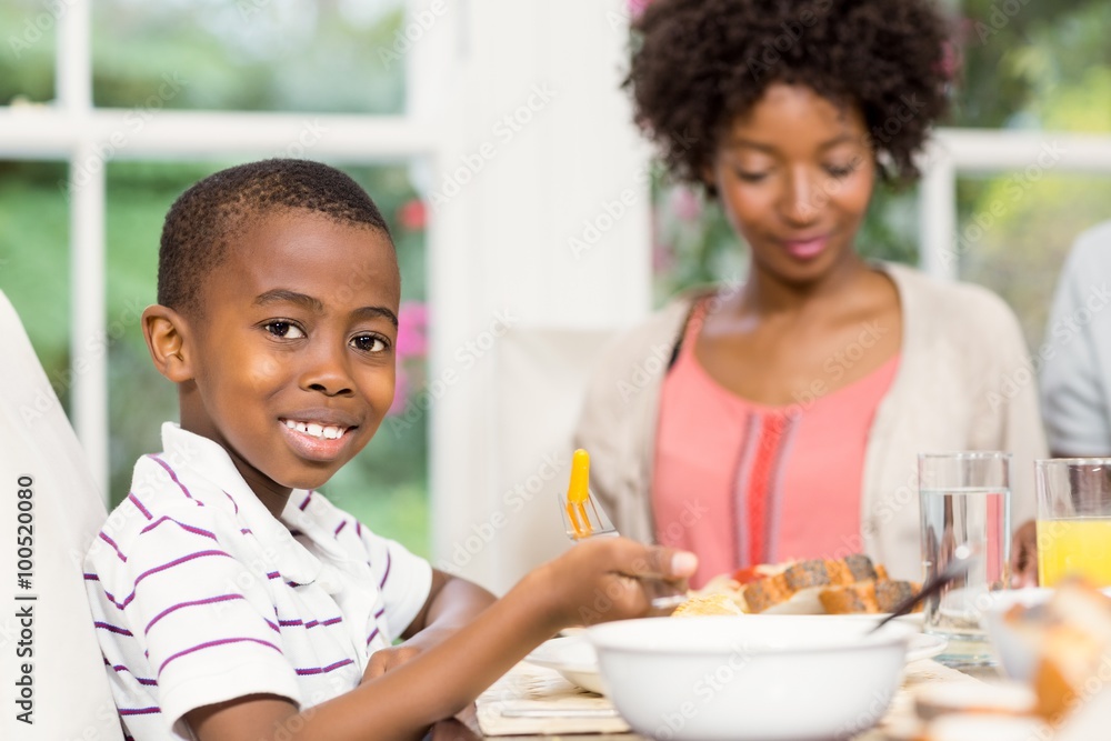 Smiling son eating his dinner Smiling son eating his dinner