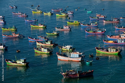Fishing boats moored off the shore at Quy Nhon, Vietnam photo