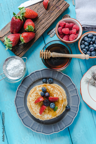 Overhead view on pancakes stack with fruit