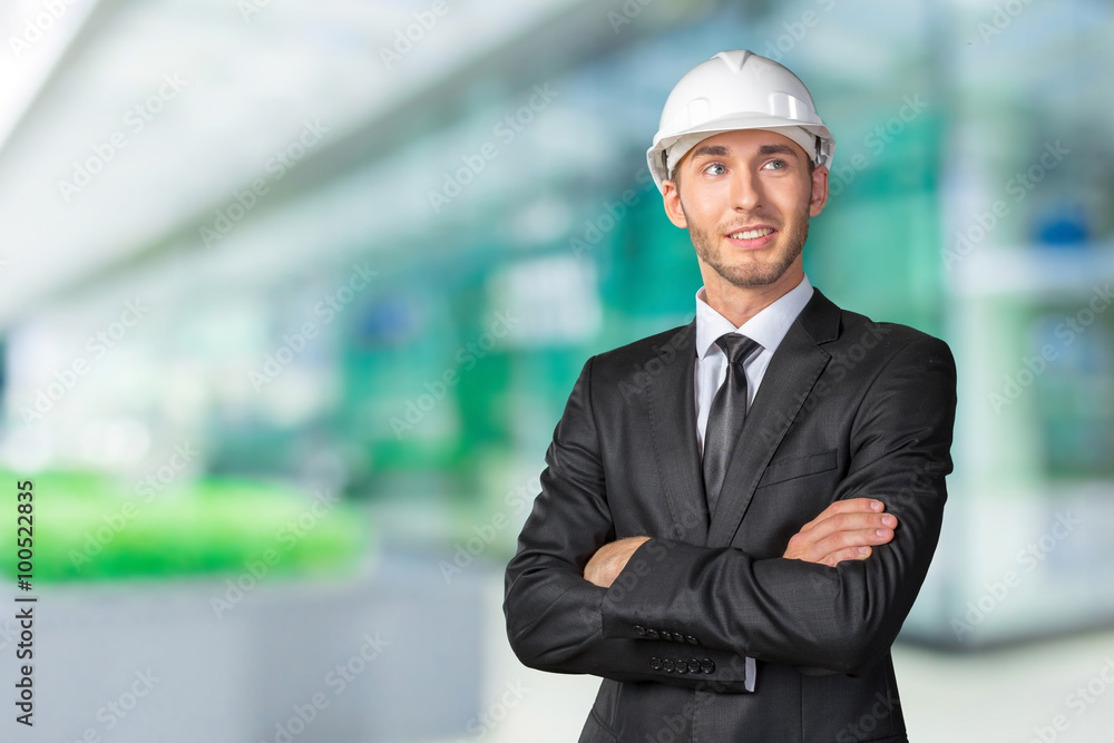 Young handsome engineer in white hardhat Young handsome engineer in white hardhat