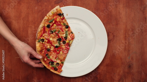 Hands taking pizza cuts. Stop motion animation, top view, 4K.