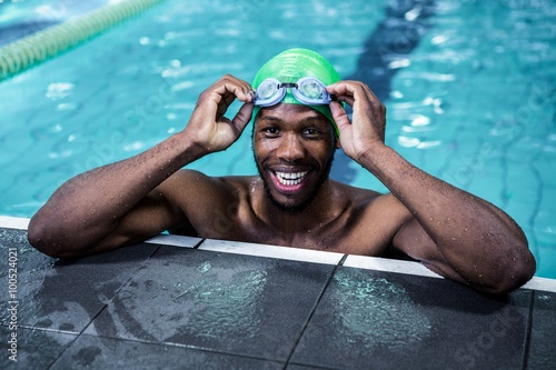 Smiling fit african american man in the swimming pool photo