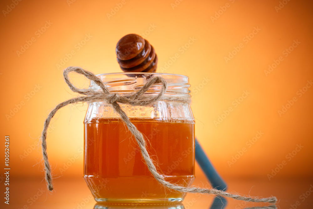 Natural honey in a glass jar Natural honey in a glass jar