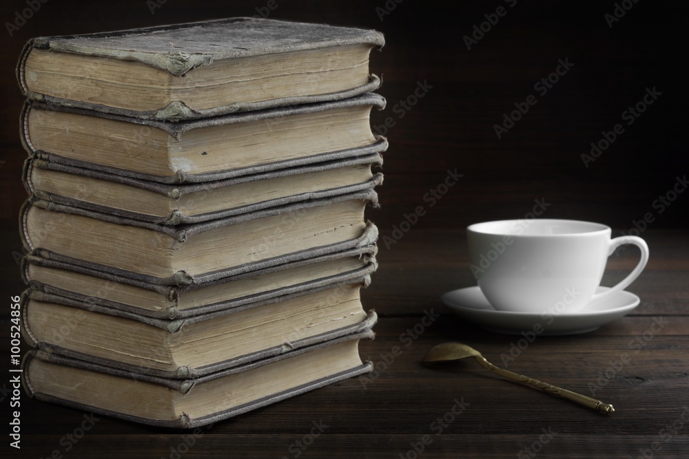 Old Shabby Books And White Cup On The Wood Background Old Shabby Books And White Cup On The Wood Background