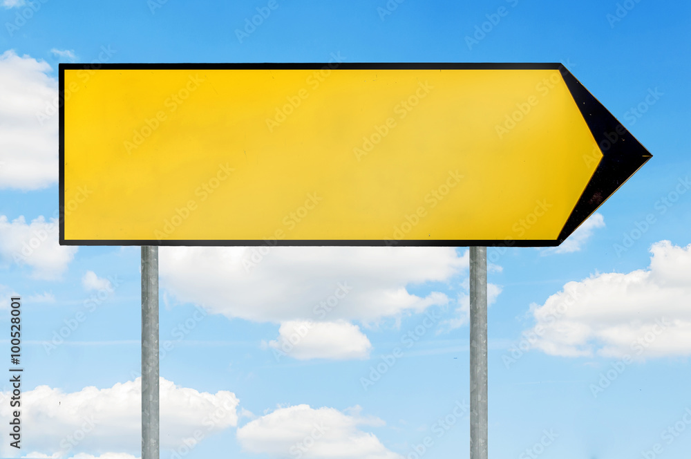 Blank yellow road sign for text with arrow to right direction against blue cloudy sky Blank yellow road sign for text with arrow to right direction against blue cloudy sky