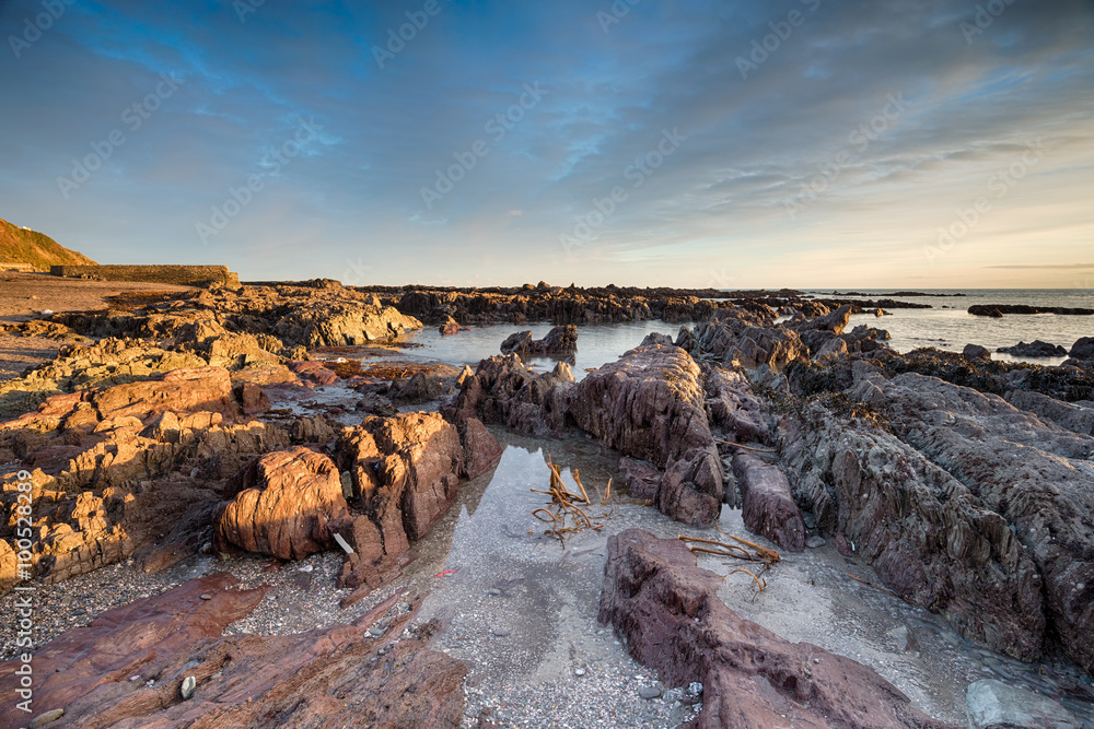 Rock pools at low tide on Hoodny beach at Portwrinkle on the Cornish coast
