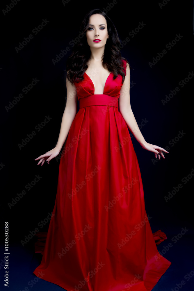 Beautiful sexy brunette with red low cut dress