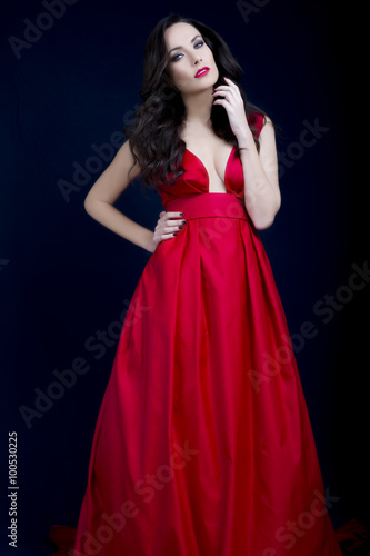 Beautiful sexy brunette with red low cut dress