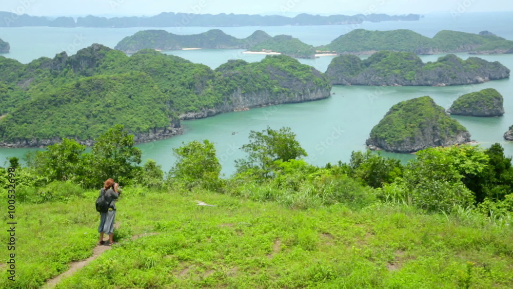Zoom out, tourist girl taking picture, limestone halong bay Zoom out, tourist girl taking picture, limestone halong bay