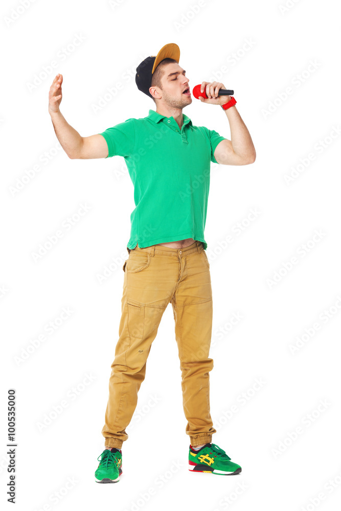 Portrait of young male hip hopper singing in studio isolated on Portrait of young male hip hopper singing in studio isolated on