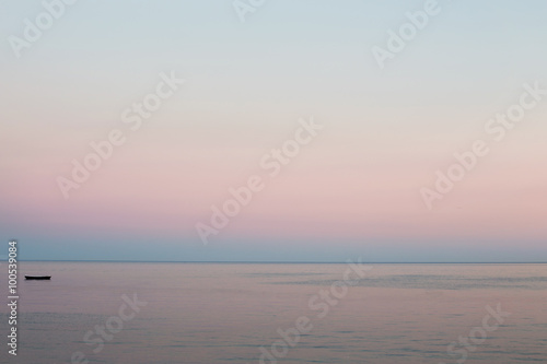 Peaceful morning at the sea. Soft pink colors of the sunrise