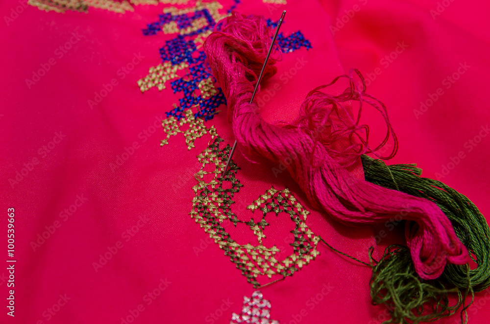 needle and thread on an embroidered shirt needle and thread on an embroidered shirt