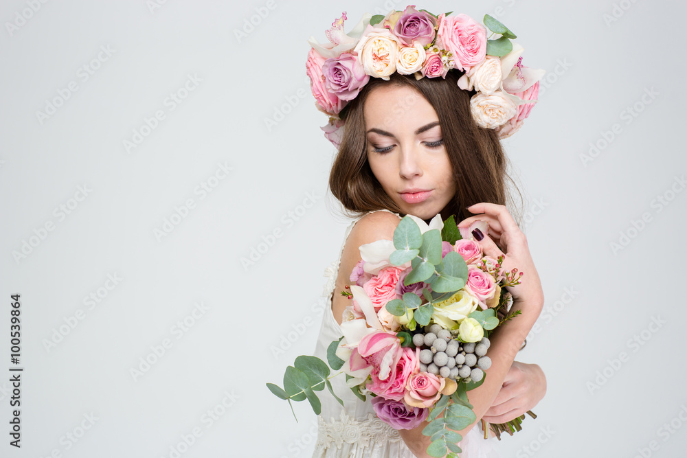 Romantic lovely woman in wreath of roses with flower bouquet Romantic lovely woman in wreath of roses with flower bouquet