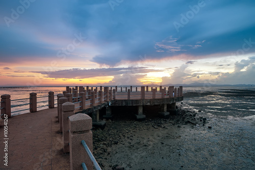 Beautiful colorful sunset by the muddy beach