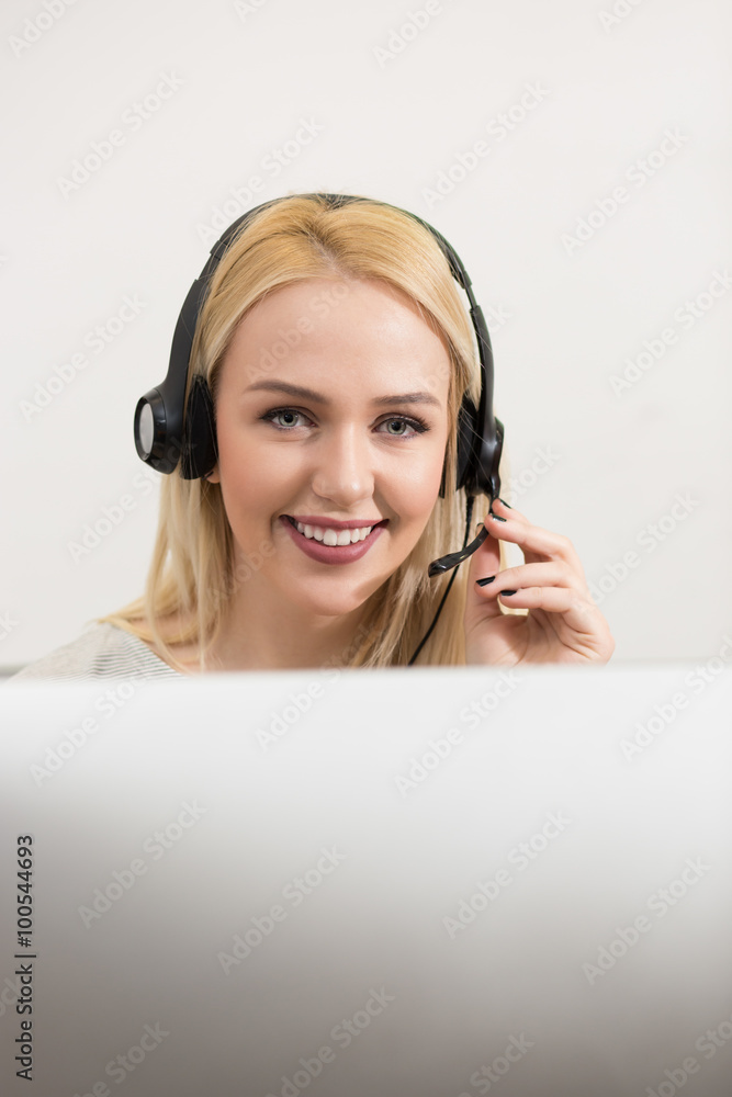 Female customer support operator with headset and smiling Female customer support operator with headset and smiling
