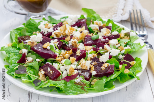 Salad with beets, feta cheese and walnuts, dressed with balsamic sauce