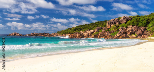 Paradise beach and sea, shaped granite boulders and a perfect white sand at Grand Anse beach, La Digue island, Seychelles