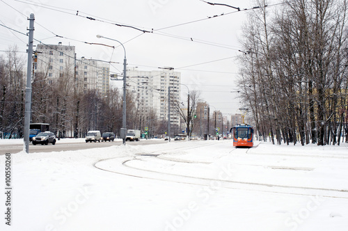 Orange tram and car road in winter