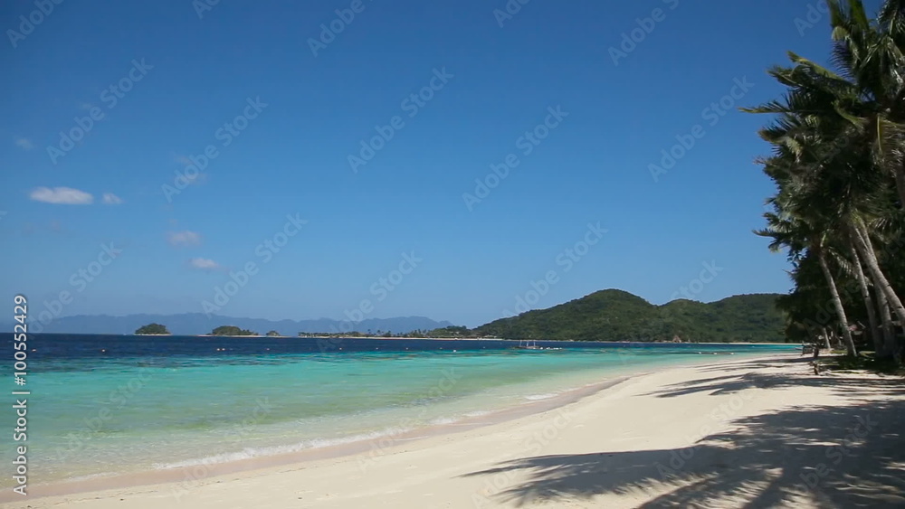 Tropical white sand beach,blue sky, clouds wihh coconut palms.Wave running on coast of tropical island.Concept travel.Beautiful tropical beach with clear blue water. Tropical white sand beach,blue sky, clouds wihh coconut palms.Wave running on coast of tropical island.Concept travel.Beautiful tropical beach with clear blue water.