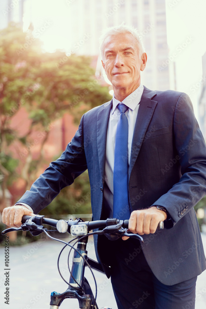 Fototapeta premium Successful businessman riding bicycle