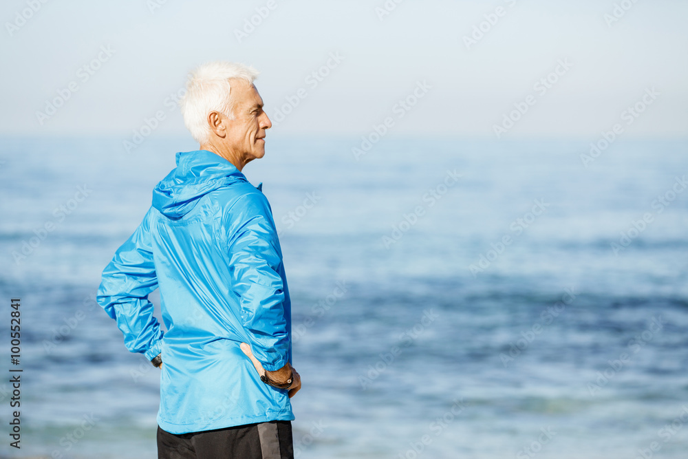 Man standing on beach in sports wear Man standing on beach in sports wear