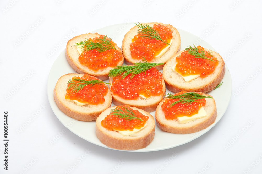 Bread with butter and red caviar in white plate. Sandwiches with