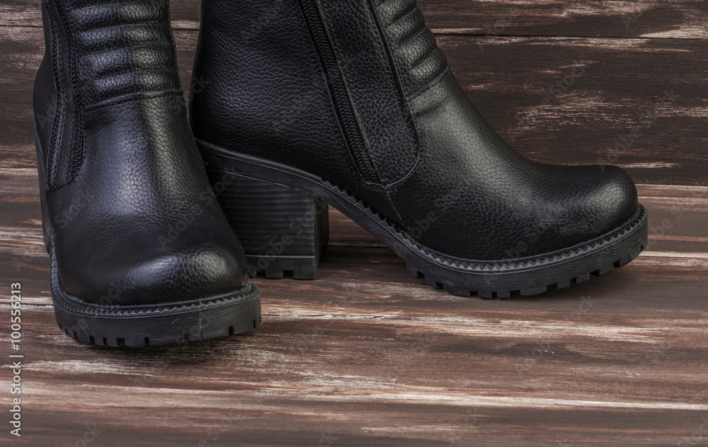 pair of leather boots on wooden surface