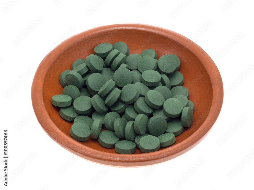 Green iron supplement tablets in a small bowl Green iron supplement tablets in a small bowl