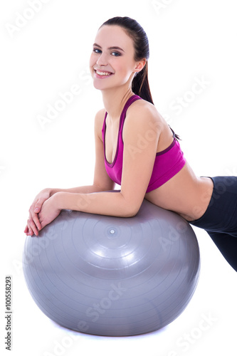 happy slim woman in sports wear with fitness ball isolated on wh © Di Studio