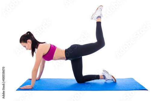 beautiful slim woman doing stretching exercises on yoga mat isol