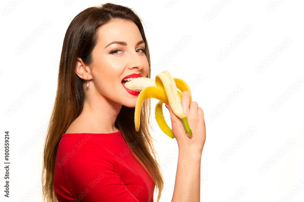 Sexy Woman in Clothes Eating Banana on White Background Isol Photo | Adobe Stock