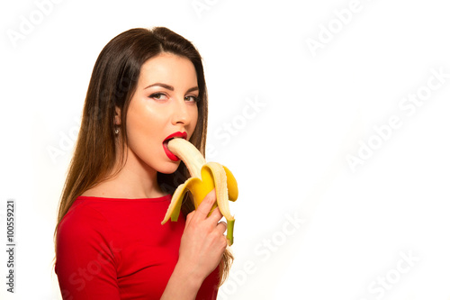Sexy Woman in Red Clothes Eating Banana on White Background Isol