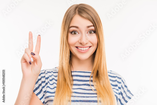 Cute girl gesturing with two fingers Stock Photo