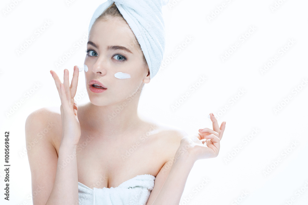 Skin care woman putting face cream / Young woman touching her face. Photo composition of blond girl - isolated on white background Skin care woman putting face cream / Young woman touching her face. Photo composition of blond girl - isolated on white background