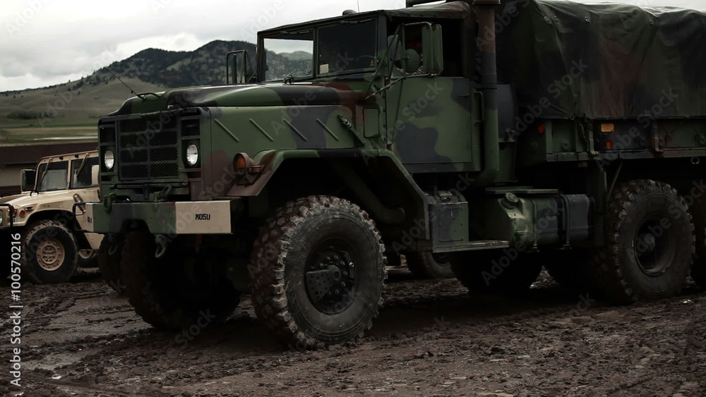 Military convoy truck starting and driving away. Military convoy truck starting and driving away.
