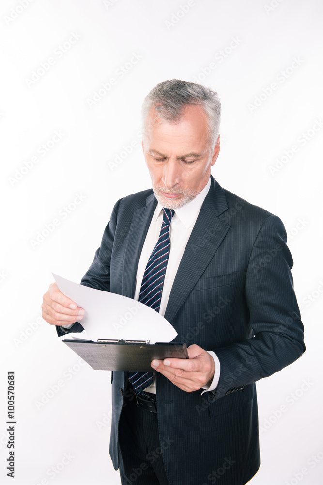 A portrait of aged focused man working with clipboard A portrait of aged focused man working with clipboard
