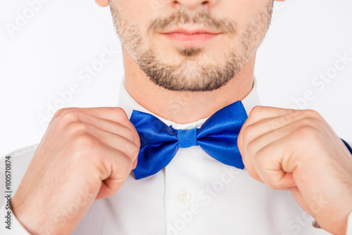 Closeup photo of a young man bounding a bow