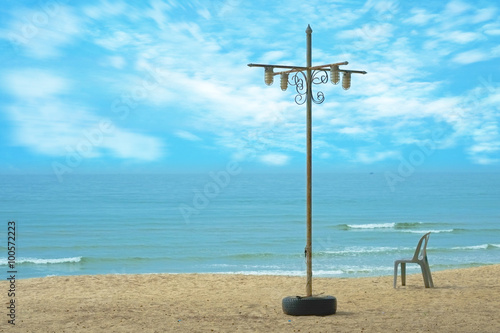 Sand beach / Lamp and plastic chair on sand beach.