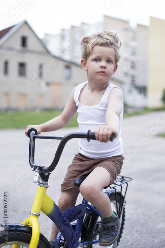 Child on a bicycle at asphalt road. Childhood. Sport. Cycling