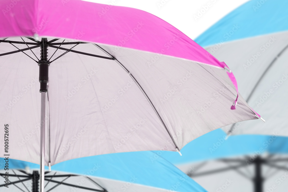 Pink umbrella / Close up pink umbrella on blue umbrella background.