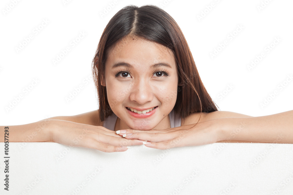 Beautiful young Asian woman behind a blank sign Beautiful young Asian woman behind a blank sign