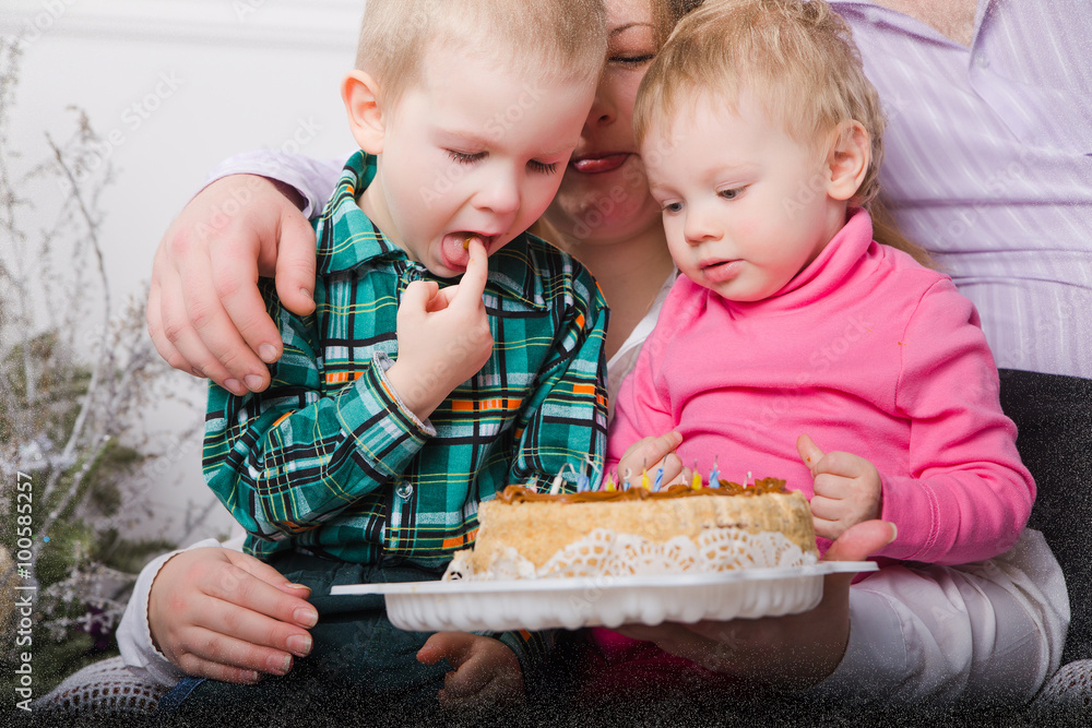 happy family with two kids with cake at home happy family with two kids with cake at home