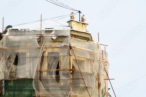 Old building renovation with protective nets, repair and renovate