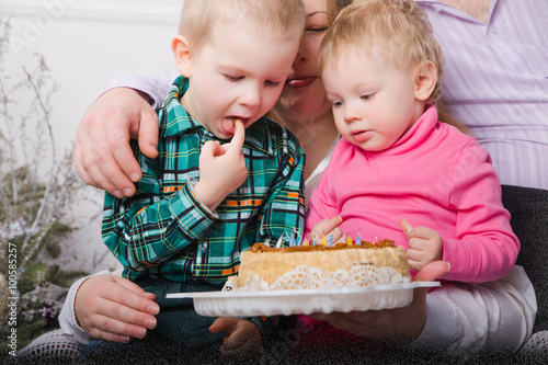 happy family with two kids  with cake at home