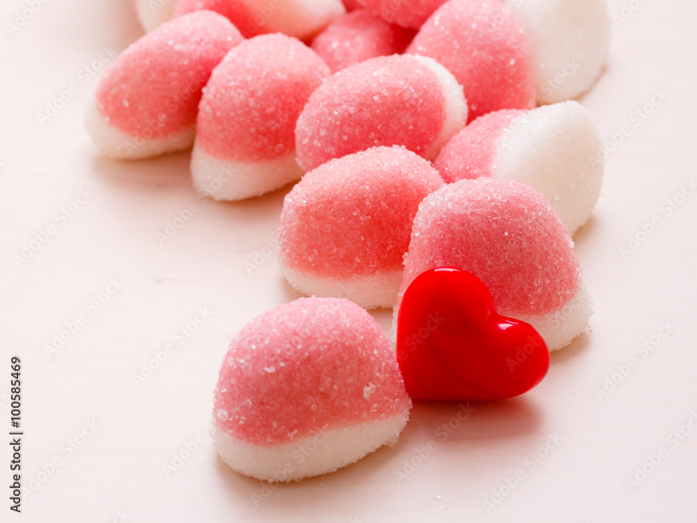 Pink jellies or marshmallows with sugar on table Pink jellies or marshmallows with sugar on table