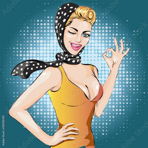 Pop Art winks woman with ok gesture . Pin-up girl.