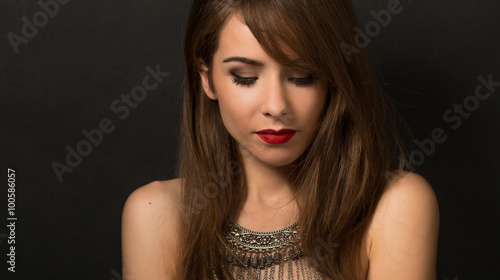 Beautiful lady posing with necklace in studio